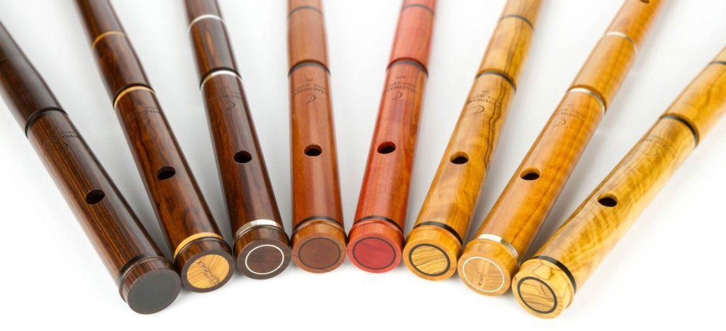 A set of eight flutes made from three hardwoods (mopane, pink ivory and African olivewood), in a range of different, attractive colours.