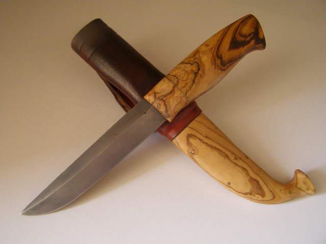 A knife with African olive handle and sleeve.