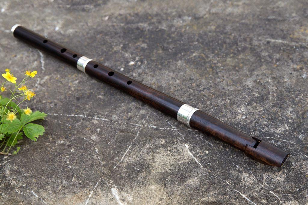 A beautiful, dark-coloured flute made of African leadwood (also called elegant wood) and silver.