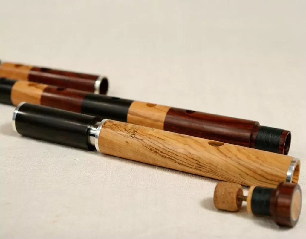 Pipes made of three different African tonewoods for woodwind, from light-coloured olive wood to medium-brown mopane and dark African leadwood.