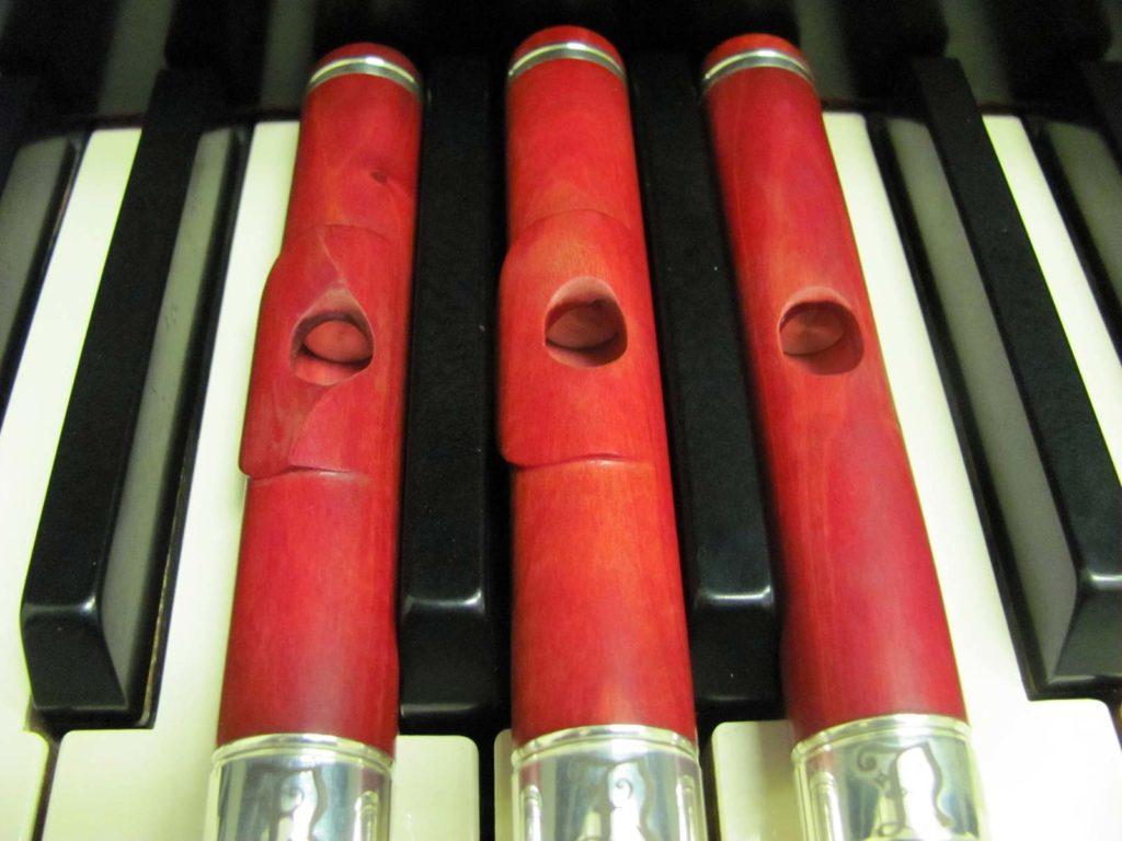 Three pink ivory flute headjoints.